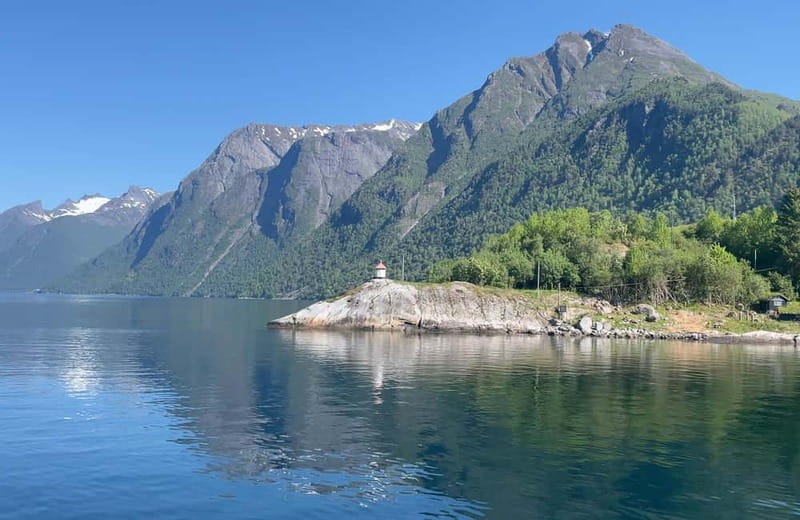 All About the Fjords, in one tour by bus & boat from Ålesund - Hellesylt: shops, cafés, and the waterfall running through town