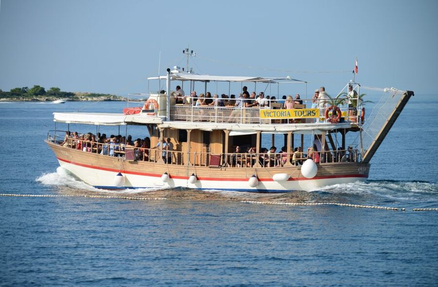From Poreč: Lim Fjord, Rovinj, and Vrsar Boat Trip - Boarding the traditional wooden boat for Lim Fjord lunch and wine